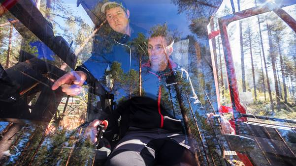Komatsu operator being instructed in cab